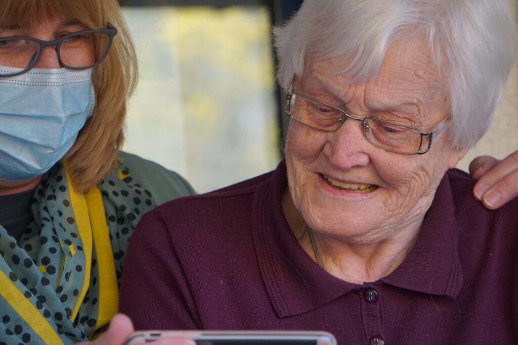 caregiver helps elderly woman